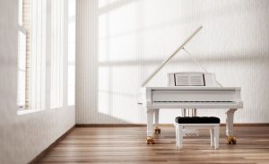 A white grand piano with an open sheet of music sits in a sunlit room with wooden floors and tall windows. The mood is serene and elegant.