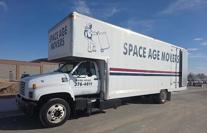 A large moving truck with the logo "Space Age Movers" parked on a sunny day, ready for transportation services.